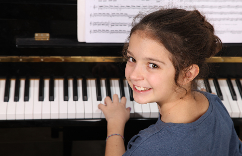 girl plays piano