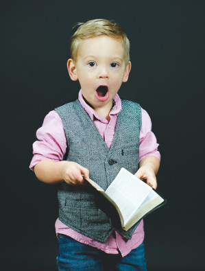 Boy singing with book